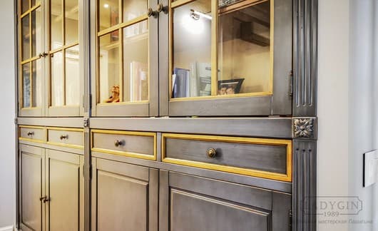 Выдвижные ящики деревянного встроенного книжного шкафа в классическом французском стиле со стеклянными дверками фото